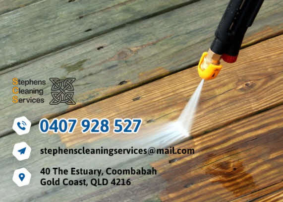 Wooden deck being cleaned with a power washer.