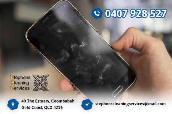 A person cleaning a mobile phone screen with a microfiber cloth