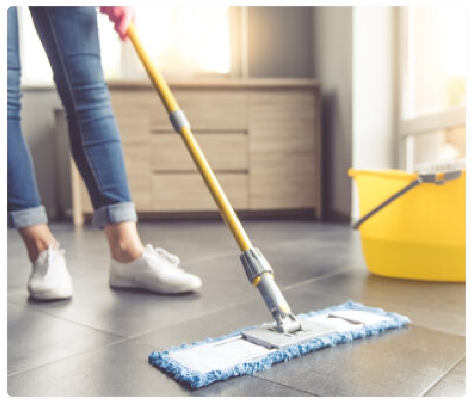 A lady cleaning tiles with a mopping stand