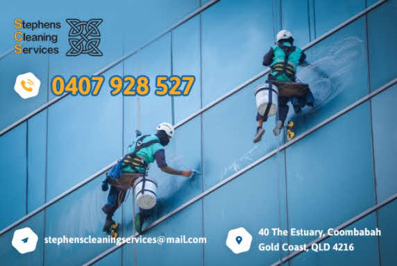 Two men cleaning windows with ropes and tools